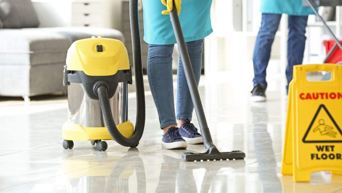 Woman vacuuming title floor